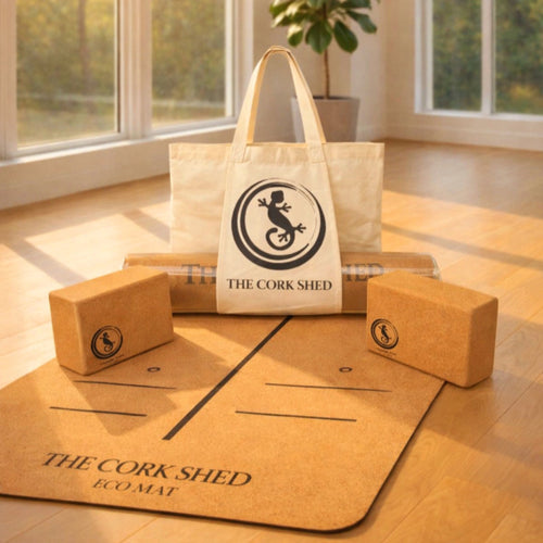 Yoga mat, blocks, and tote bag with 'The Cork Shed' logo on a wooden floor.